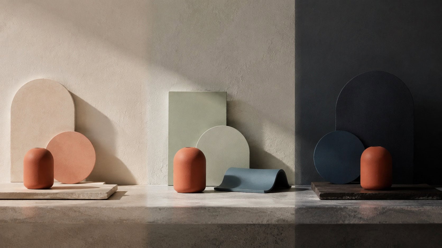 Abstract shapes in terracotta, sage green, blue, and cream, arranged across a light and dark background.