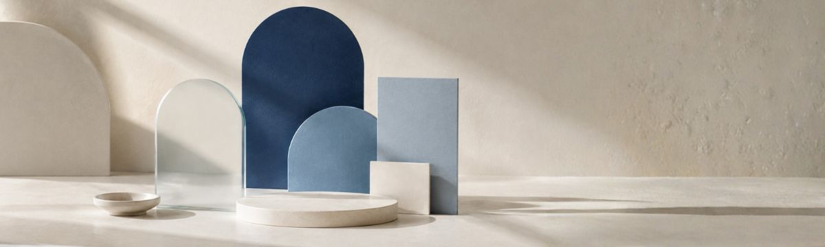 Abstract composition of pale blue, dusty blue and deep navy geometric forms in soft daylight.