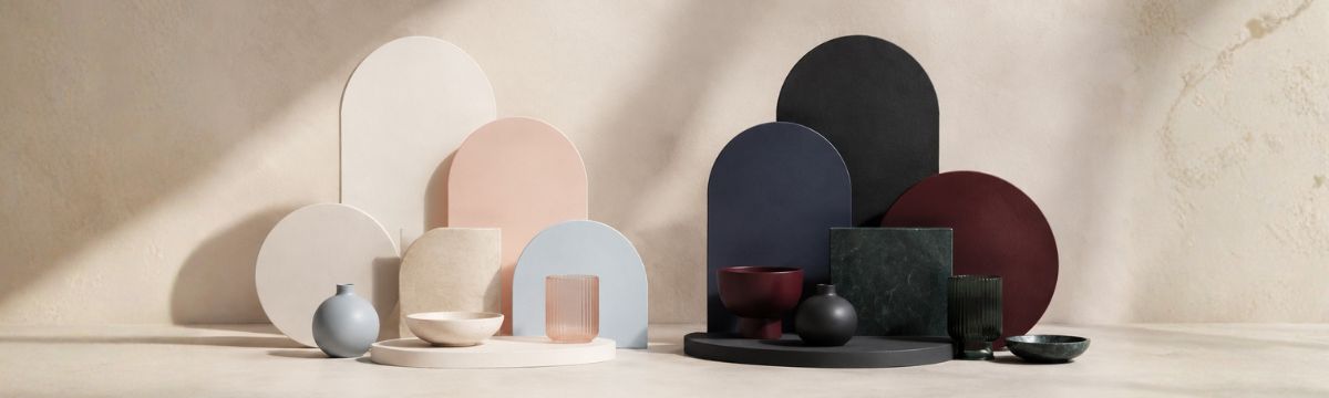 Paired light and dark geometric palettes show how pale and deep colors create different atmospheres in the same studio setting.