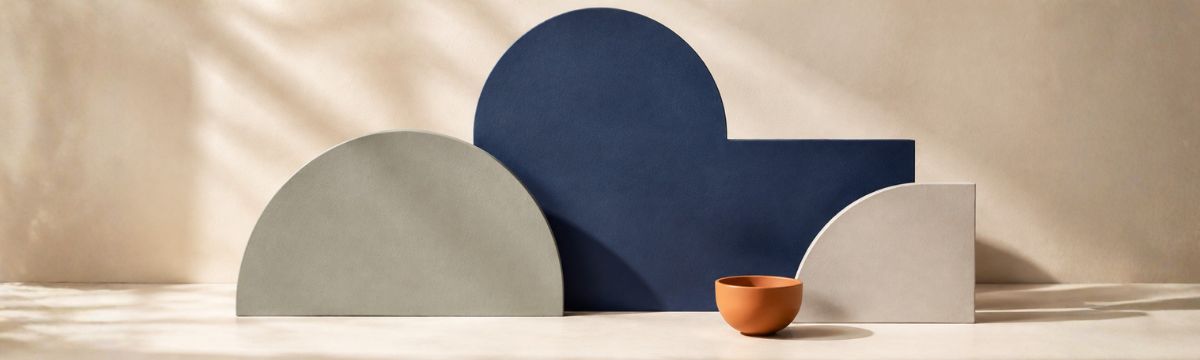 Layered palette with a dominant navy form, supporting sage and cream forms and a small orange accent.