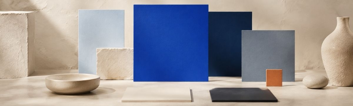 Blue website palette with a primary blue, lighter and darker variations, neutral colors and a small orange accent.